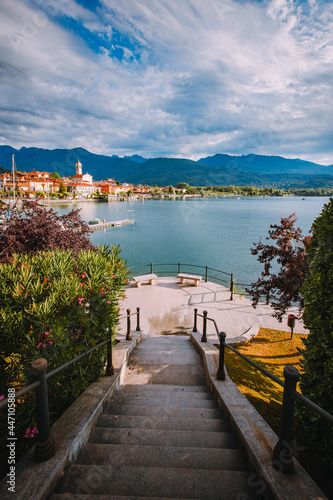 Feriolo, Verbania / Italy - June 2021: Feriolo village on Lake Maggiore with cloudy sky and steps to walk along the lake in the foreground