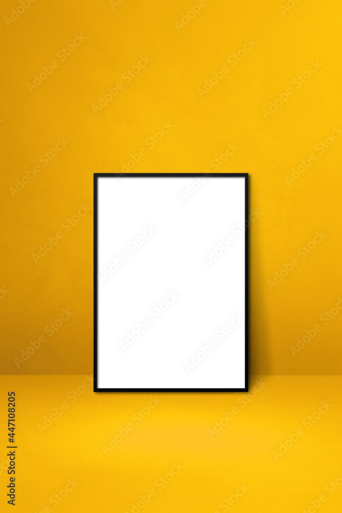 Black picture frame leaning on a yellow wall Black picture frame leaning on a yellow wall