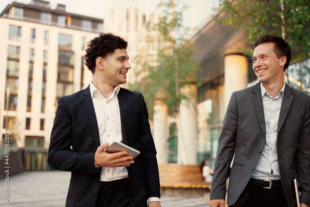 Colleagues are discussing a new project in construction. Young entrepreneurs in business suits go to work. A new business center in the city center. Colleagues are discussing a new project in construction. Young entrepreneurs in business suits go to work. A new business center in the city center.