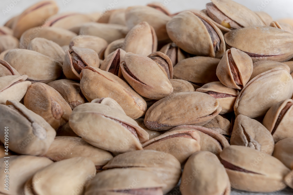 Heap of tasty pistachio with shell background. Pistachio nuts texture, banner for web. Selective focus. Close up. Heap of tasty pistachio with shell background. Pistachio nuts texture, banner for web. Selective focus. Close up.