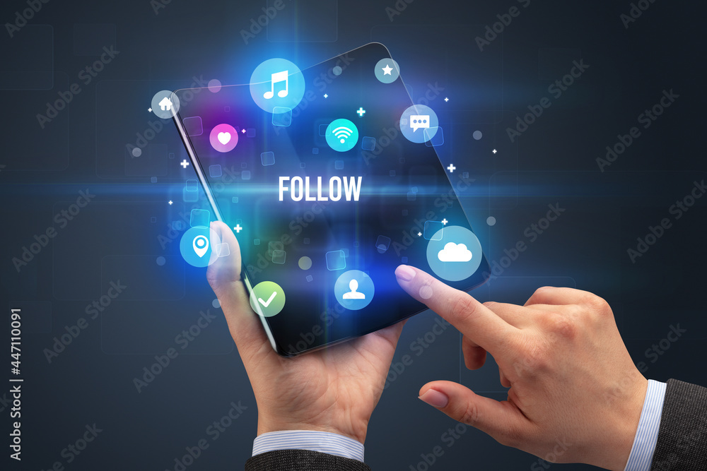 Businessman holding a foldable smartphone Businessman holding a foldable smartphone