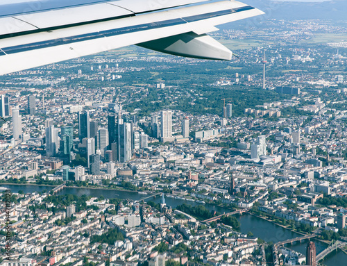  airplane wing over Frankfurt city skyline