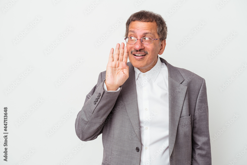 Middle aged indian business man isolated on white background is saying a secret hot braking news and looking aside Middle aged indian business man isolated on white background is saying a secret hot braking news and looking aside