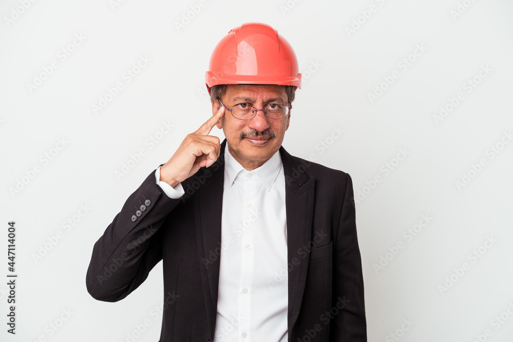 Middle aged indian architect man isolated on white background pointing temple with finger, thinking, focused on a task. Middle aged indian architect man isolated on white background pointing temple with finger, thinking, focused on a task.