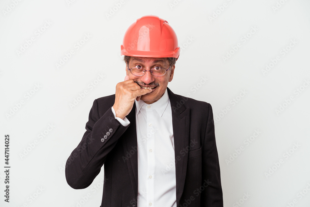 Middle aged indian architect man isolated on white background biting fingernails, nervous and very anxious. Middle aged indian architect man isolated on white background biting fingernails, nervous and very anxious.
