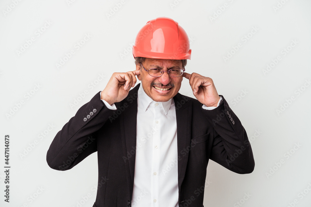Middle aged indian architect man isolated on white background covering ears with hands.