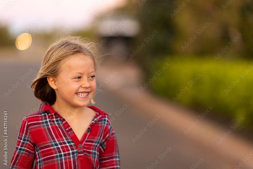 little girl happily smiling in evening light little girl happily smiling in evening light