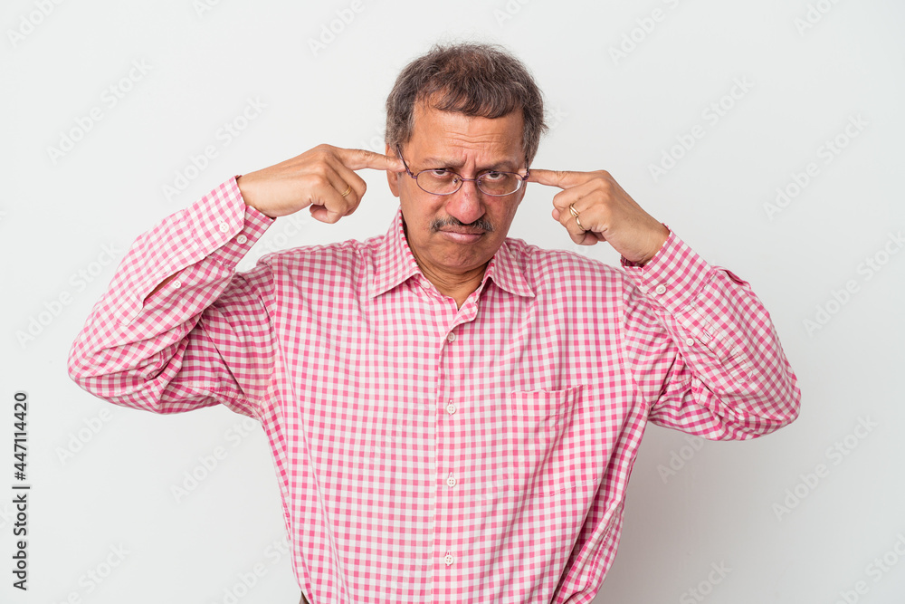 Middle aged indian man isolated on white background focused on a task, keeping forefingers pointing head. Middle aged indian man isolated on white background focused on a task, keeping forefingers pointing head.
