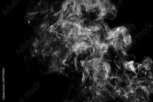 Black and white photo of smoke clouds on a black background