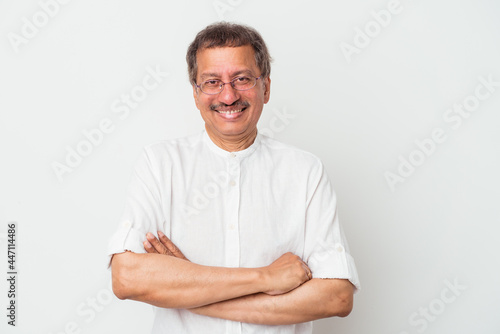 Middle aged indian man isolated on white background who feels confident, crossing arms with determination.