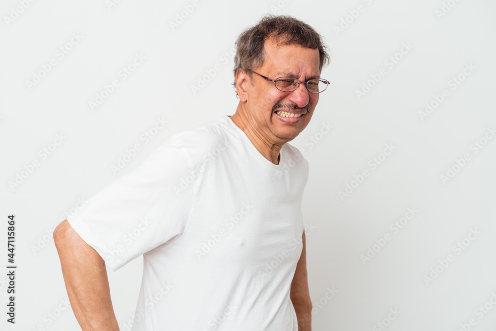 Middle aged indian man isolated on white background suffering a back pain. Middle aged indian man isolated on white background suffering a back pain.
