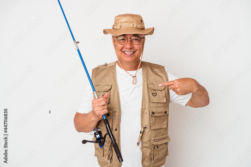 Senior american fisherman holding rod isolated on white background person pointing by hand to a shirt copy space, proud and confident Senior american fisherman holding rod isolated on white background person pointing by hand to a shirt copy space, proud and confident