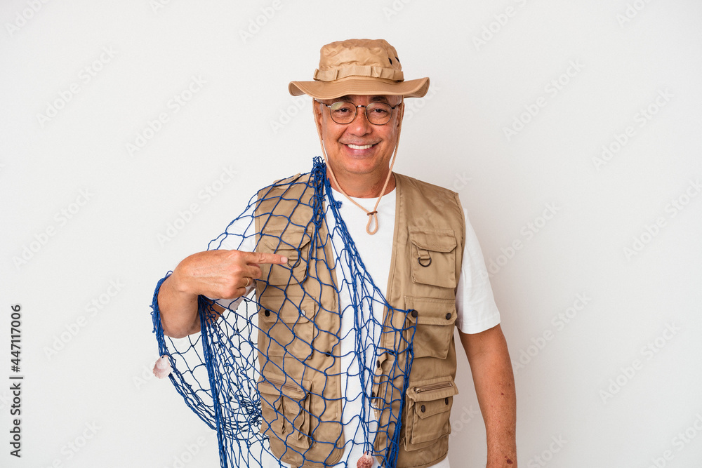Senior american fisherman holding net isolated on white background person pointing by hand to a shirt copy space, proud and confident Senior american fisherman holding net isolated on white background person pointing by hand to a shirt copy space, proud and confident