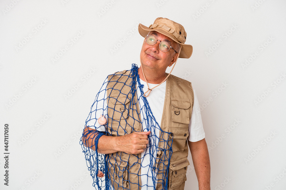 Senior american fisherman holding net isolated on white background dreaming of achieving goals and purposes Senior american fisherman holding net isolated on white background dreaming of achieving goals and purposes