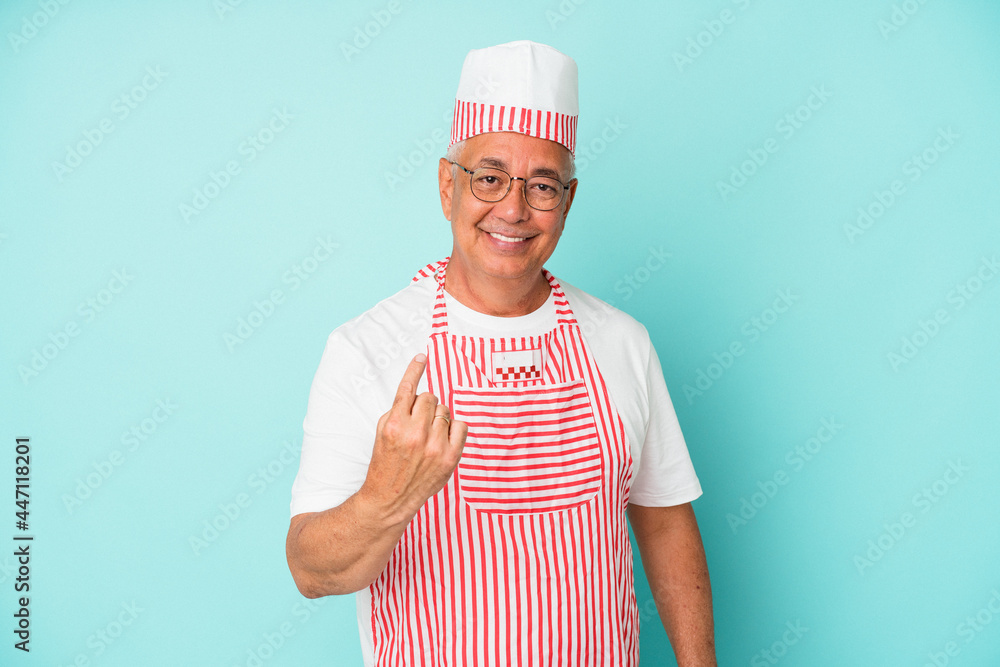 Senior american ice cream man woman holding isolated on blue background pointing with finger at you as if inviting come closer. Senior american ice cream man woman holding isolated on blue background pointing with finger at you as if inviting come closer.