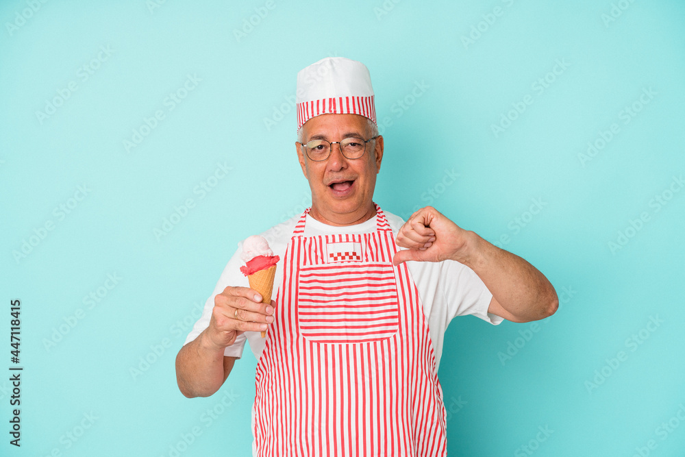 Senior american ice cream maker holding an ice cream isolated on blue background feels proud and self confident, example to follow. Senior american ice cream maker holding an ice cream isolated on blue background feels proud and self confident, example to follow.