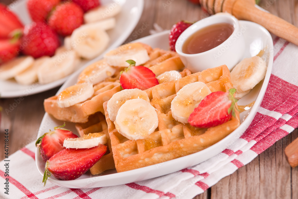 Waffles with strawberries, bananas and honey. Waffles with strawberries, bananas and honey.