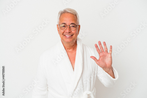 Senior american man wearing bathrobe isolated on white background smiling cheerful showing number five with fingers. © Asier