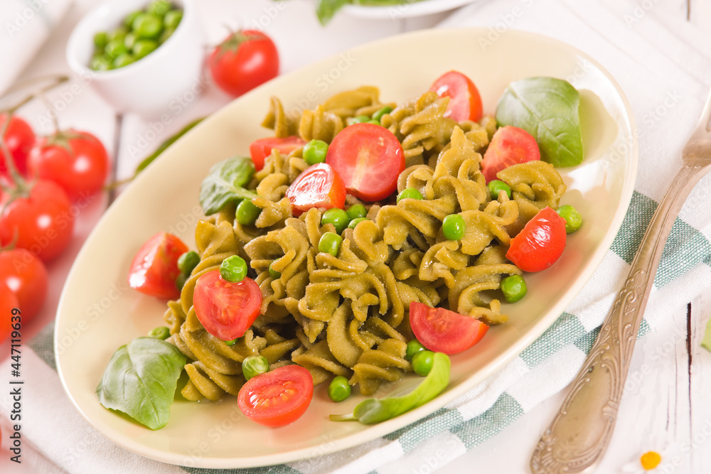 Fusilli pasta with cherry tomatoes and peas. Fusilli pasta with cherry tomatoes and peas.