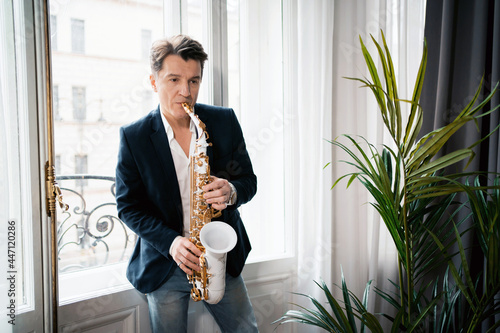 Canvas Print Portrait of an adult male music teacher playing the saxophone.
