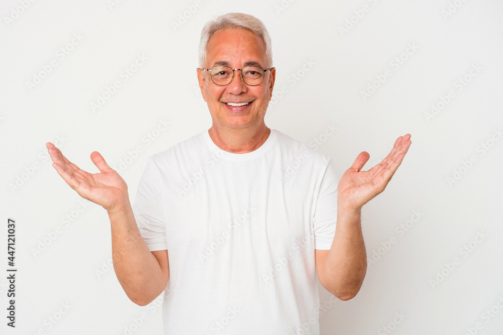 Senior american man isolated on white background makes scale with arms, feels happy and confident. Senior american man isolated on white background makes scale with arms, feels happy and confident.