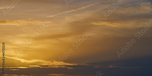 Colorful cloudy sky on the sunset as a natural background. © Arthur