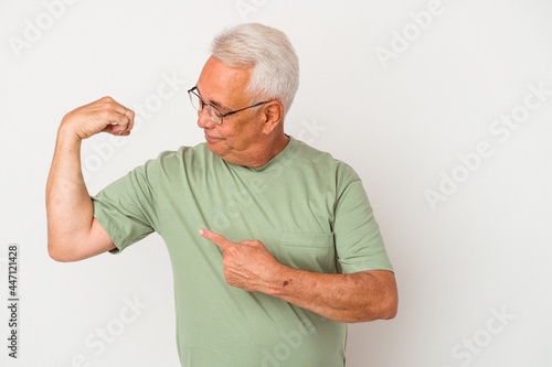 Senior american man isolated on white background showing strength gesture with arms, symbol of feminine power