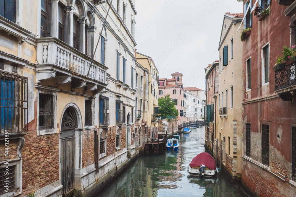 Narrow canal by traditional Venetian house, Venice, Italy