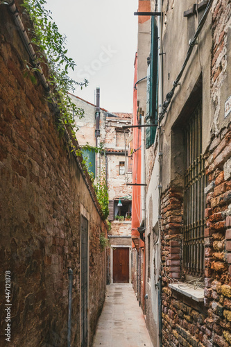 Narrow alley between traditional Venetian houses  Venice  Italy