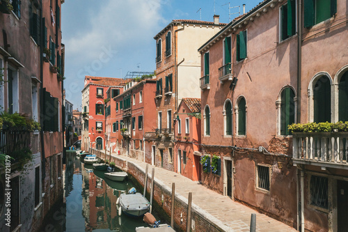 Narrow canal by traditional Venetian house, Venice, Italy © Mark Zhu