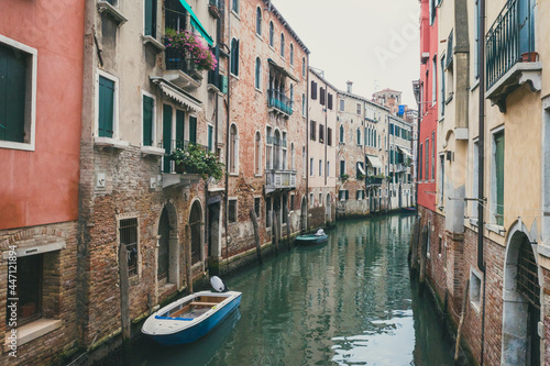 Narrow canal by traditional Venetian house, Venice, Italy © Mark Zhu