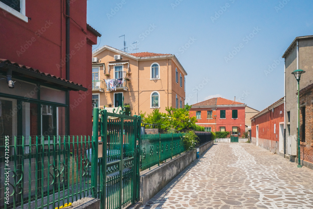 Empty street between houses on island of Murano, Venice, Italy
