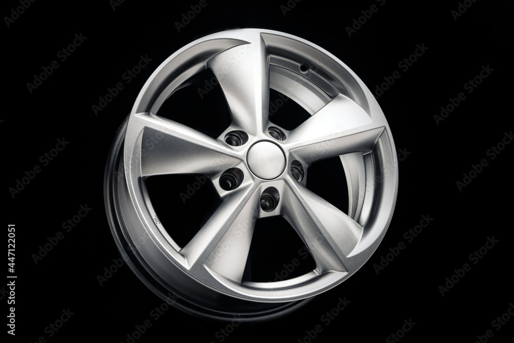 car alloy wheel, new five-spoke silver on a black background, auto parts for car tuning.