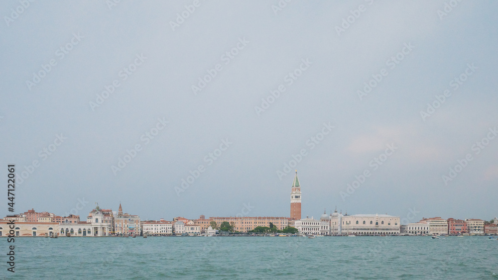 Island of Venice under cloudy sky over water in Venice, Italy