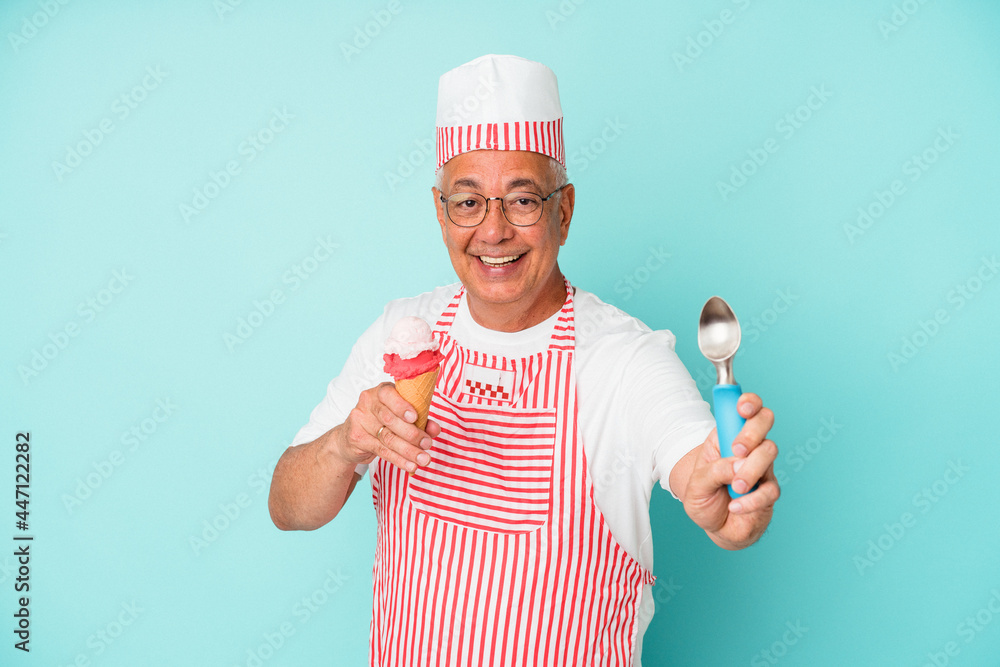 Senior american ice cream maker holding an ice cream isolated on blue background Senior american ice cream maker holding an ice cream isolated on blue background