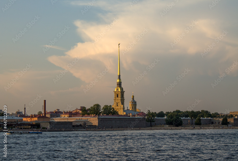 Saint Petersburg, RUSSIA-July, 15, 2021: view of the yellow tower with the spire of the Peter and Paul Fortress and the Neva River on a summer day and a space for copying