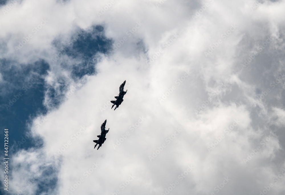 a group of combat aircraft perform complex aerobatics with a smoke launch against the sky a group of combat aircraft perform complex aerobatics with a smoke launch against the sky