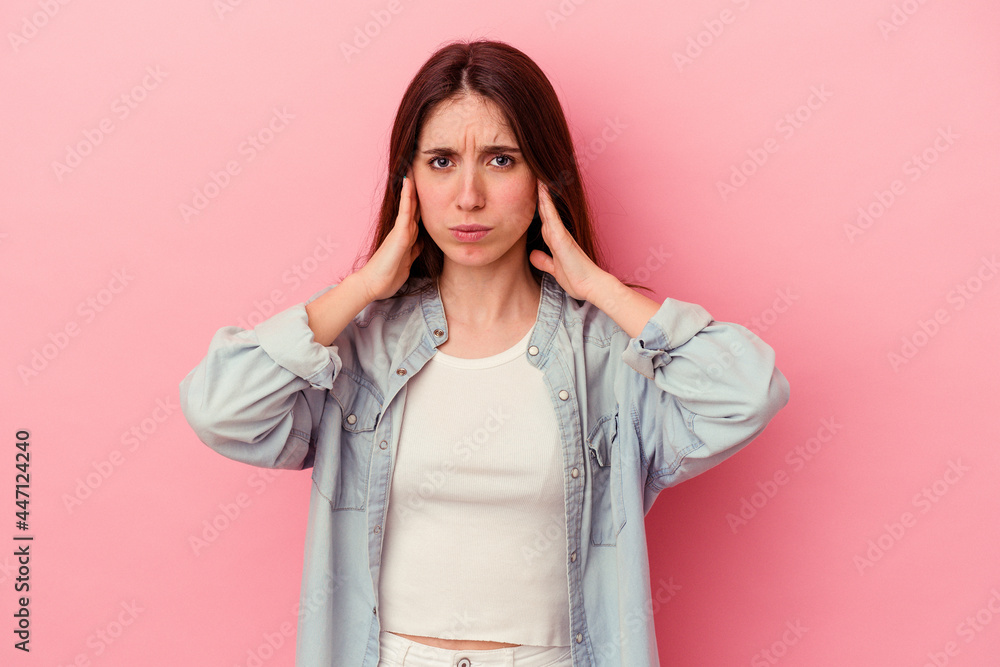 covering ears with fingers, stressed and desperate by a loudly ambient.