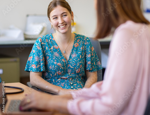 Young female at medical appointment in doctors surgery photo