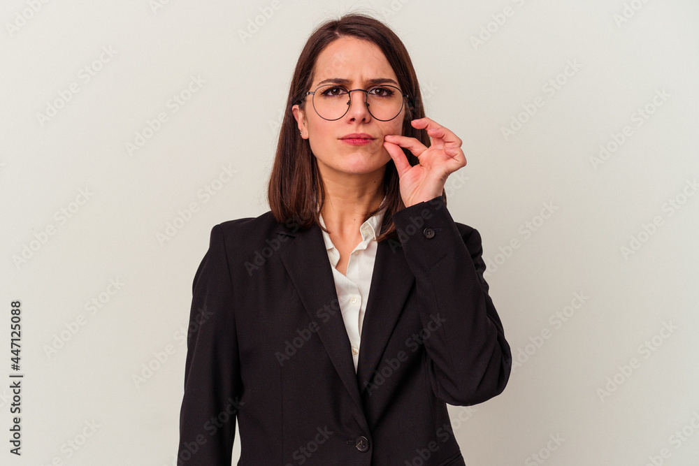 Young business woman isolated on white background with fingers on lips keeping a secret. Young business woman isolated on white background with fingers on lips keeping a secret.
