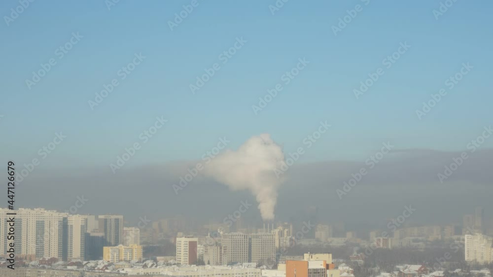 city pipes emit steam into the arctic atmosphere against the city skyline city pipes emit steam into the arctic atmosphere against the city skyline