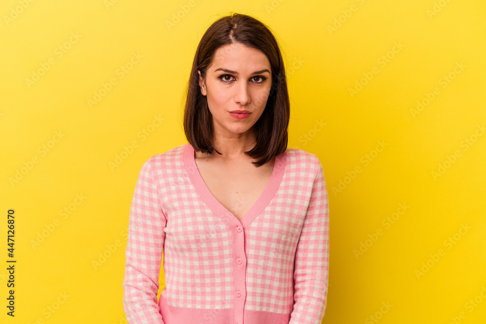 Fototapeta premium Young caucasian woman isolated on yellow background sad, serious face, feeling miserable and displeased.