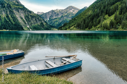 Scenic mountain lake in Austria. Vintage rowboat on emerald green, clear water alpine lake. Vilsalpsee, Lake Vilsalp in the Allgäu Alps of the Tannheimer Tal, Tannheim valley. Reutte District, Tyrol.