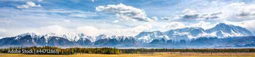 Scenic mountain range in sunlight and blue sky with clouds. Popular tourist destination in Altai Mountains. Kurai steppe in autumn.