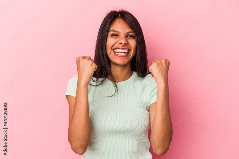 Fototapeta premium Young latin woman isolated on pink background cheering carefree and excited. Victory concept.