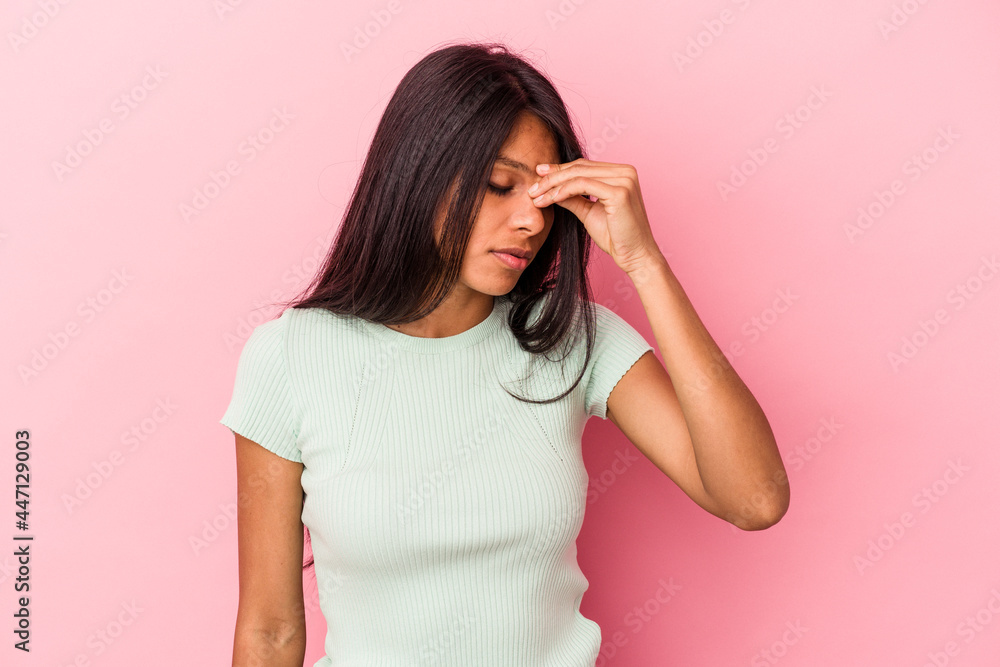 Young latin woman isolated on pink background having a head ache, touching front of the face. Young latin woman isolated on pink background having a head ache, touching front of the face.
