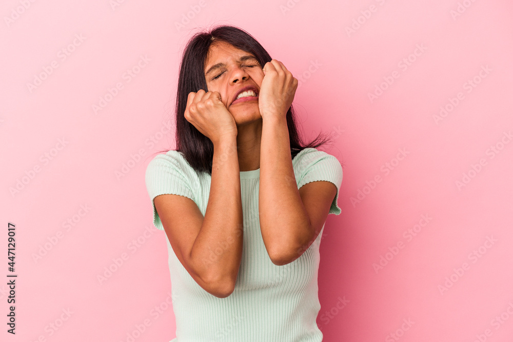 Young latin woman isolated on pink background crying, unhappy with something, agony and confusion concept. Young latin woman isolated on pink background crying, unhappy with something, agony and confusion concept.