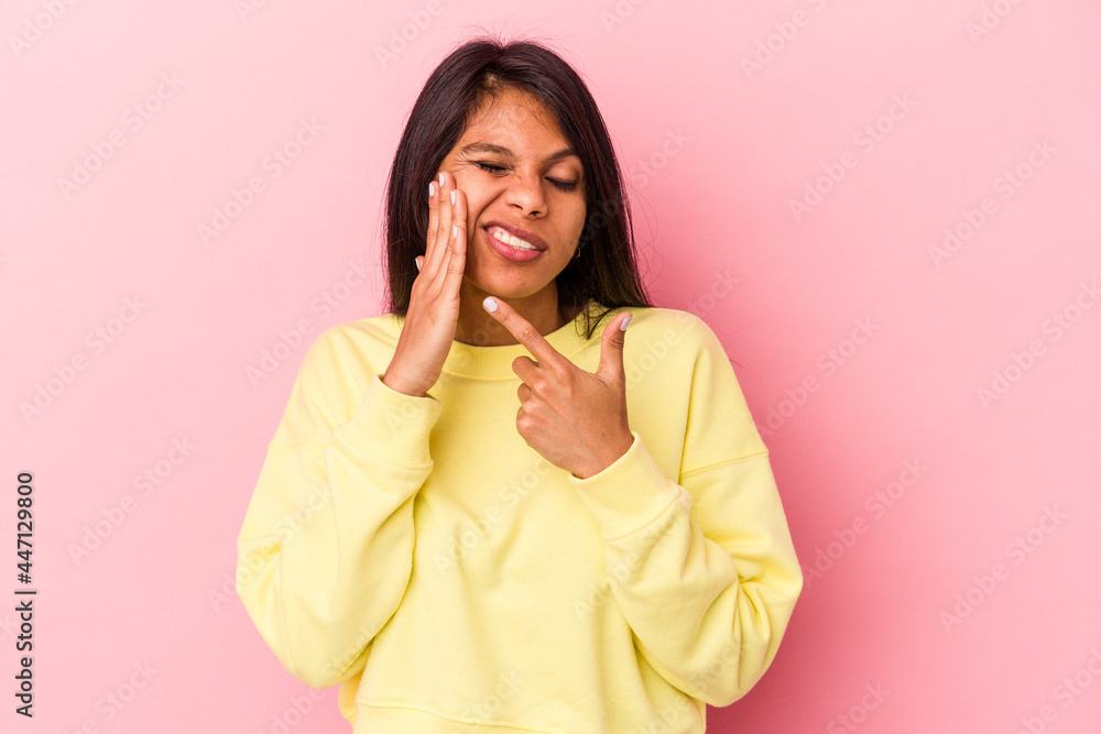 Young latin woman isolated on pink background having a strong teeth pain, molar ache. Young latin woman isolated on pink background having a strong teeth pain, molar ache.