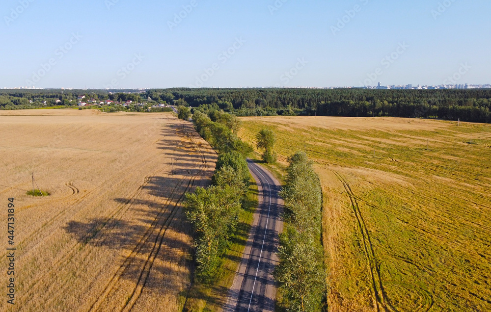 Aerial beautiful view of the summer landscape with a road near fields and meadows. Similar Tuscany countryside Italy