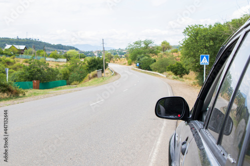 Car mirror and highway view